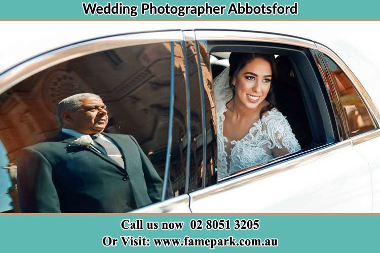 Photo of the Bride inside the bridal car and her father standing outside Abbotsford NSW 2046