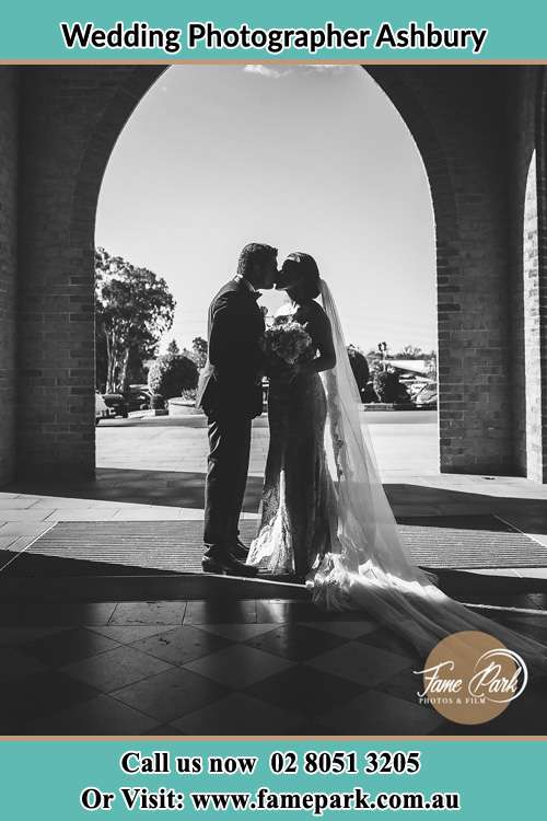 Photo of the Groom and the Bride kissing at the front of the church Ashbury NSW 2193