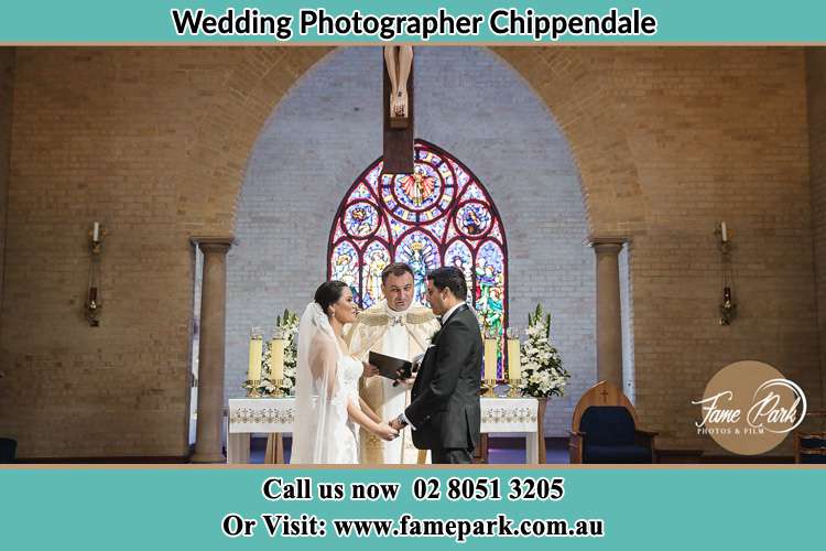 Photo of the Bride and Groom at the Altar with the Priest Chippendale NSW 2008