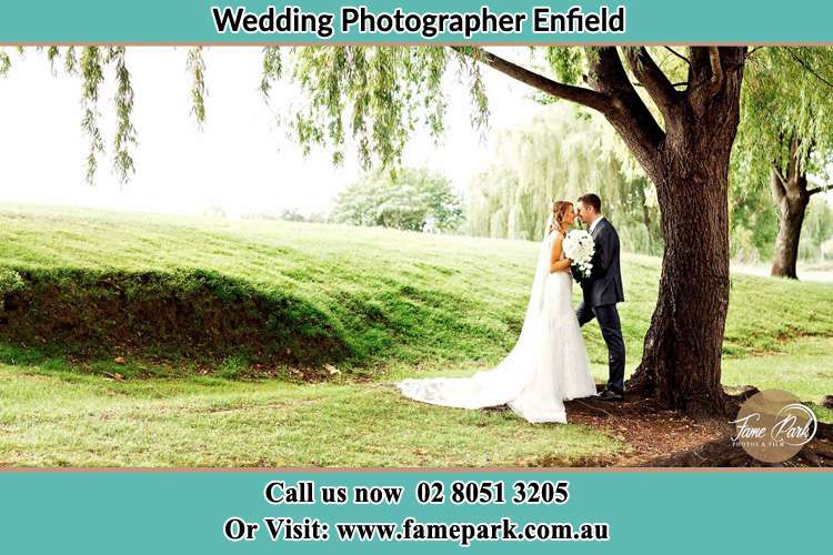 Photo of the Bride and the Groom kissing under the tree Enfield NSW 2136