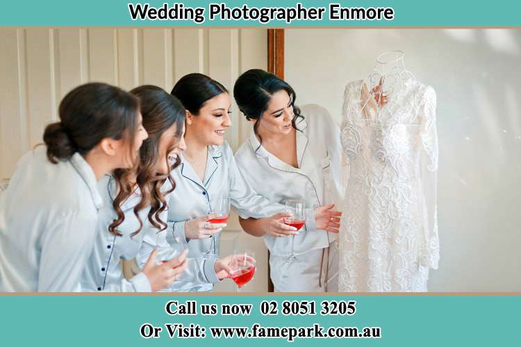 Photo of the Bride and the bridesmaids looking at the wedding gown Enmore NSW 2093