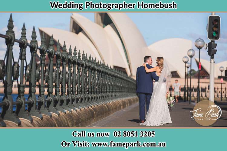 The Groom and the Bride walking towards the Sydney Grand Opera House Homebush NSW 2140