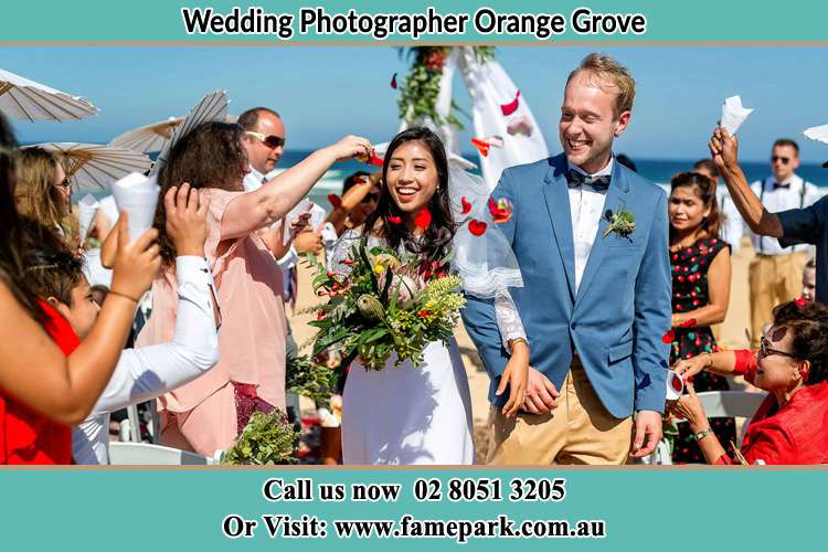 Photo of the Bride and the Groom showering flower petal by the visitors Orange Grove NSW 2380