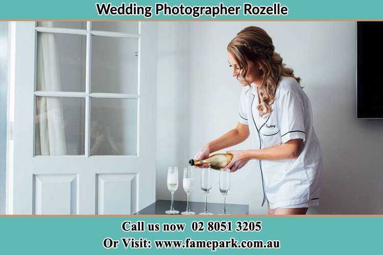 Photo of the Bride pouring wine to the glasses Rozelle NSW 2039