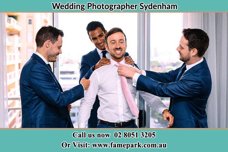 Photo of the Groom helping by the groomsmen getting ready Sydenham NSW 2044