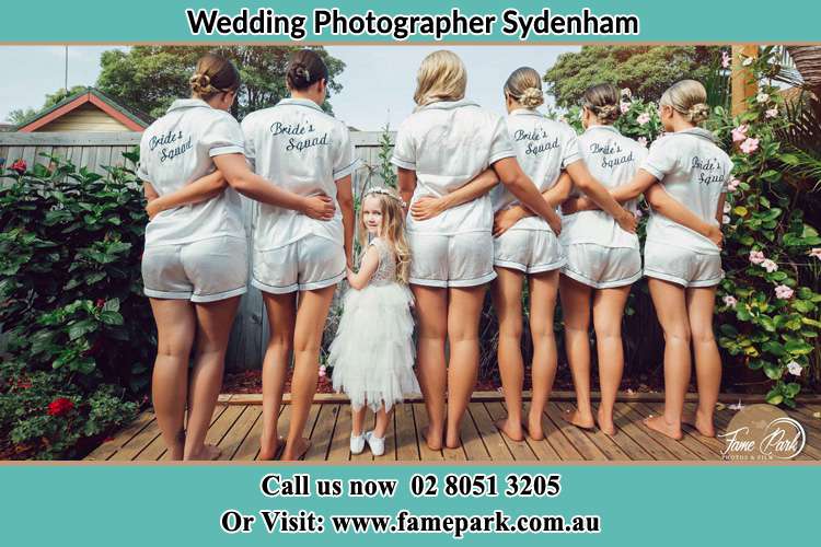 Behind photo of the Bride and the bridesmaids with the flower girl looking back Sydenham NSW 2044